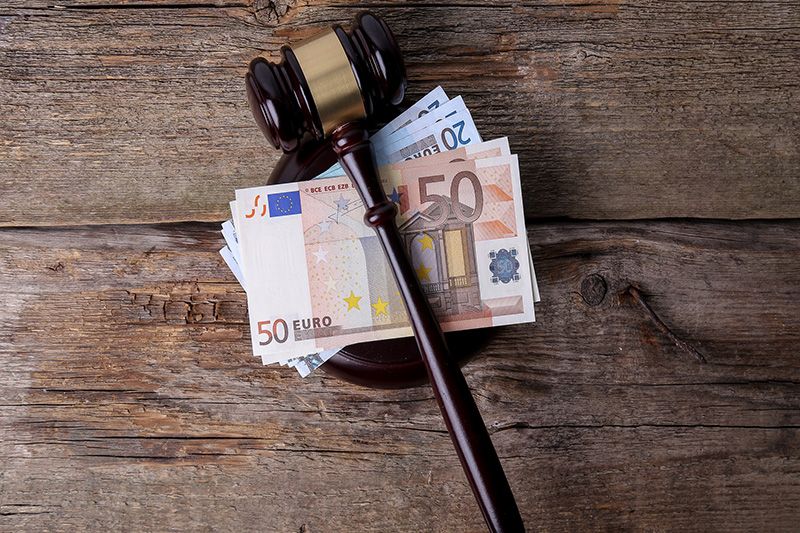 Imagen de un mazo de juez con dinero debajo.